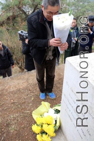 Mr. Zheng, one of many paying respects at the marker. Mr. Zheng was one of the Remembering Shared Honor volunteers who searched out the site over several years.