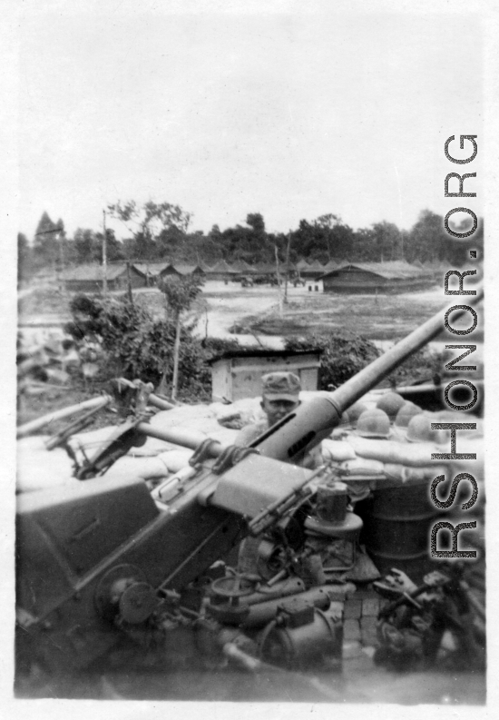 Engineer of the 2005th Ordnance Maintenance Co. working on anti-aircraft gun in India or Burma during WWII.