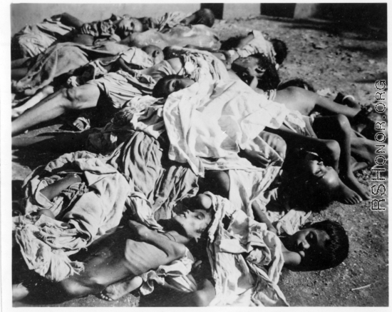Unfortunate souls, victims of famine, disease, or some other cause. In India.  Scenes in India witnessed by American GIs during WWII. For many Americans of that era, with their limited experience traveling, the everyday sights and sounds overseas were new, intriguing, and photo worthy.