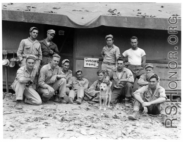 Engineers of the 797th Engineer Forestry Company pose before a building with the sign "VIRGINS HOME" in camp in Burma.  During WWII.