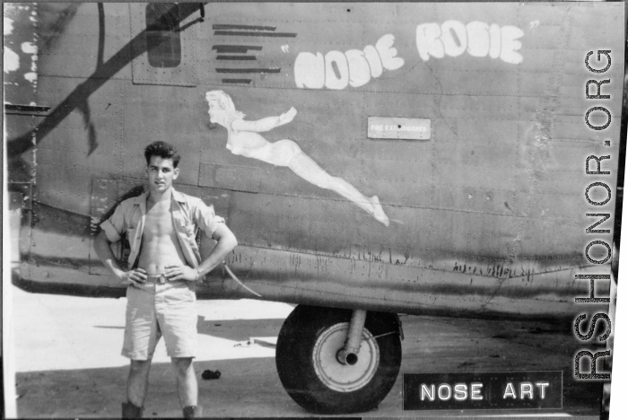 Flyer standing with B-24/F-7 "Nosie Rosie." 24th Combat Mapping Squadron, 8th Photo Reconnaissance Group, 10th Air Force