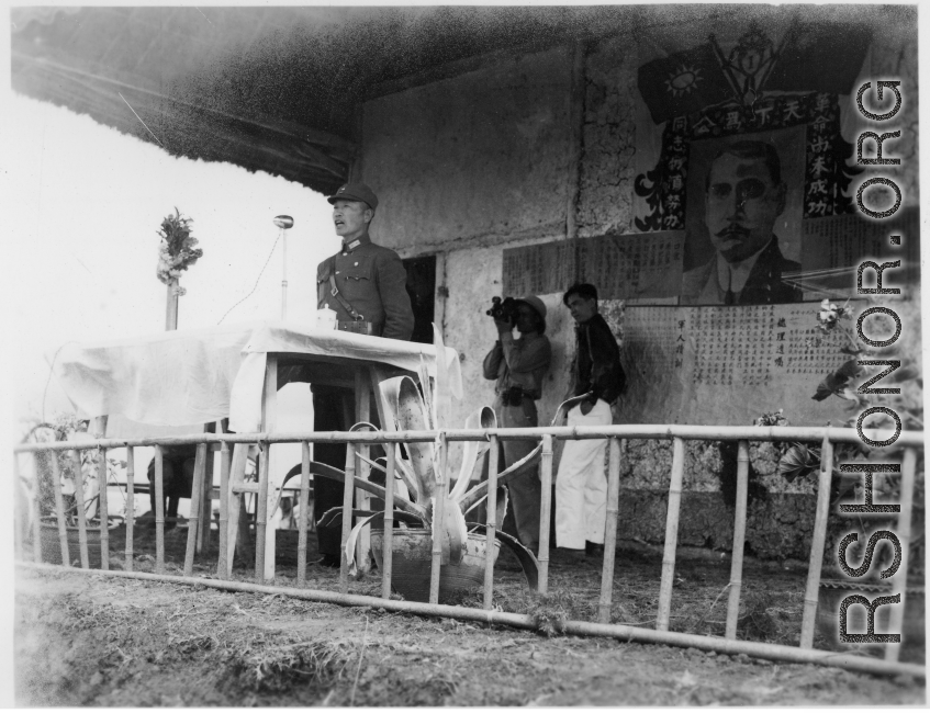 Chinese Lt. General Du Yuming, Nationalist 5th Corps (第五集团军总司令兼昆明防守司令杜聿明), makes speech during rally, while an American cameraman shoots movie film at the back.