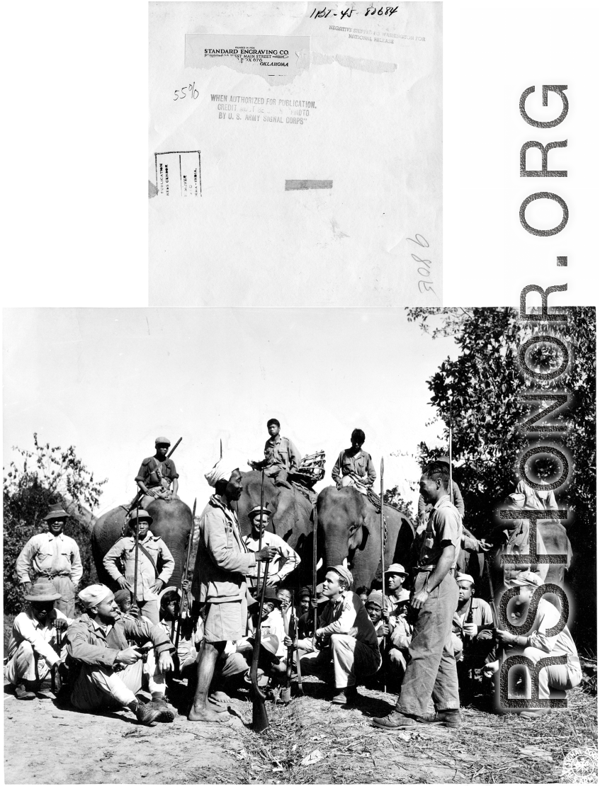 GIs pose with Kachin fighters (some riding elephants) in Burma during WWII.
