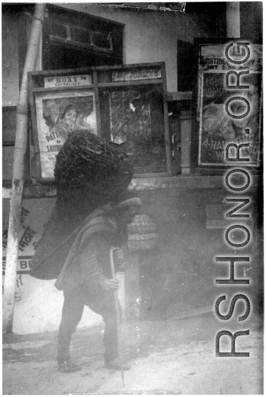 A man carries a heavy load in a giant basket in India.  Local images provided to Ex-CBI Roundup by "P. Noel" showing local people and scenes around Mussoorie, India.   In the CBI during WWII.