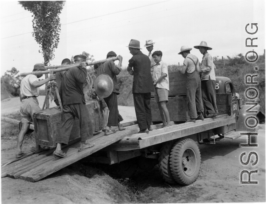 Moving supplies by truck and hard human labor in China during WWII.  From the collection of Hal Geer.