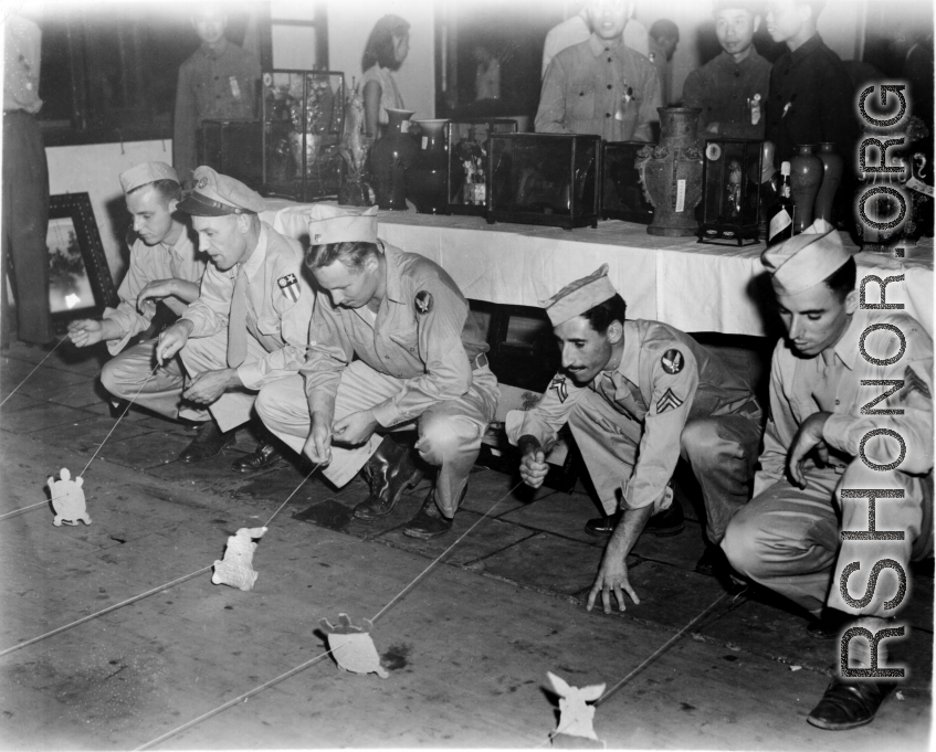 Recreation: GIs do a tortoise and the hare race, possibly at a charity event. In China during WWII.