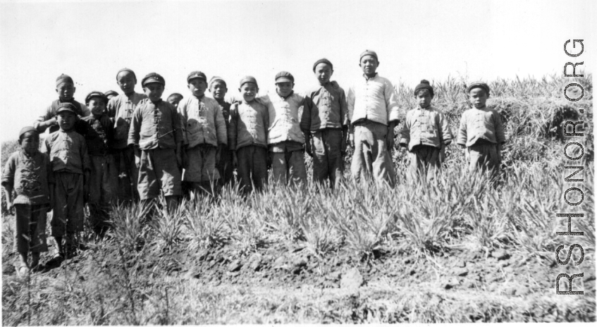 "A collection of children from several villages south of Yangkai picked up on a hike. Taking their picture was one way of having them go home.  Just before Nash & the mounds, Spring 1945."  From the collection of Frank Bates.