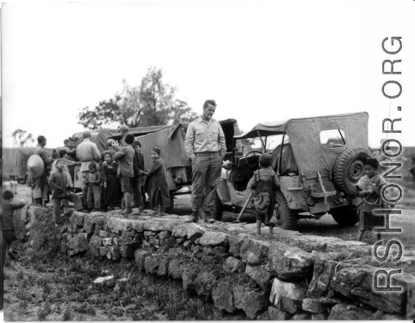 A convoy of mud-covered Jeeps in southern China.