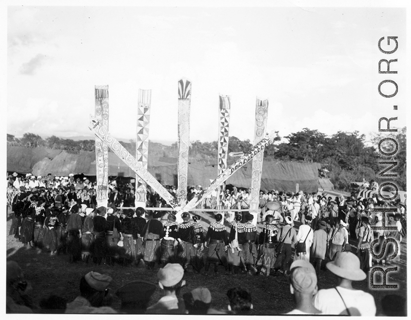 Kachin people dancing the manau dance, at the center of a Kachin community.  In Burma near the 797th Engineer Forestry Company.  During WWII.