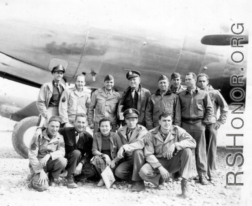 Alice Chong on the Kunming air strip posing before a C-54 with some of her 14th U.S.A.A.F buddies in 1944. Note the blood chit prominently-displayed inside the flying jacket of the Colonel Pilot at center rear. Captain Addison Bailey (in dark shirt) to Alice’s immediate right-all others unidentified.