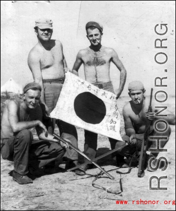 GIs show off trophy captured Japanese Good-Luck Flag  (寄せ書き日の丸) collected on the battleground in the CBI during WWII.