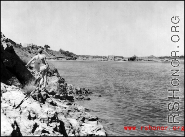 Bob Riese looks over a destroyed bridge at Liuzhou, China, during WWII, in 1945.