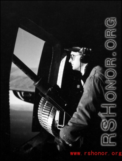 A gunner keeps lonely vigil at the waist gun on a B-24.  From the collection of Hal Geer.