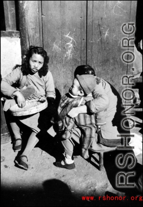 Local people in China go about their daily lives in China at roadside. During WWII.