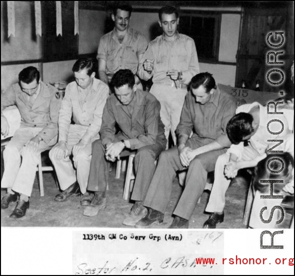 Men praying during a religious service.1139th QM Co Serv Group (AVN). Sector No. 2, CASFC.