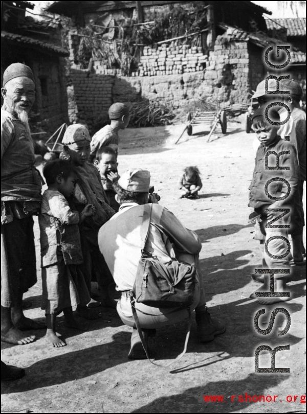 An American photographer interact with local people in a village in Yunnan during WWII.