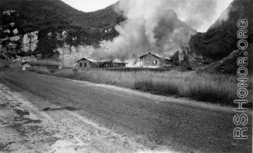 Al's notation is "Burning everything before evacuation." American hostels at the base burn during the American and Chinese retreat before the Japanese arrive in the fall of 1944.  Guangxi province, Liuzhou air base.