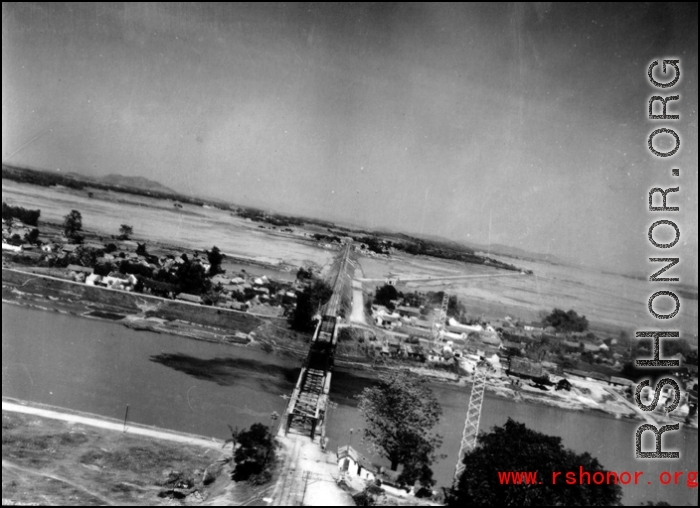 An aerial photograph of a railway bridge being bombed by the 491st Bomb Squadron in Yunnan or Indochina, during WWII.