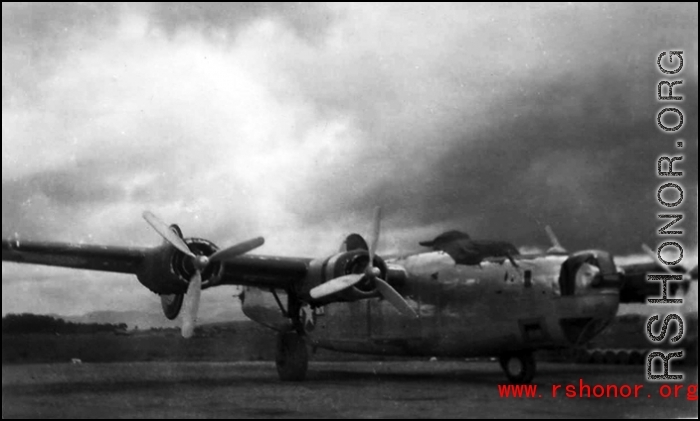 A B-24 in the CBI, with heavy storm clouds overhead.