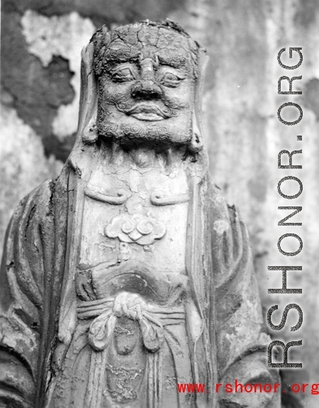 A weathered Buddhist figurine in China during WWII.