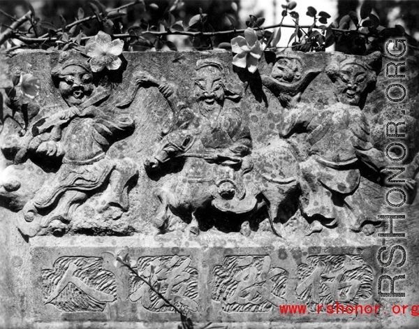 Carvings on a gravestone in Yunnan province, China.