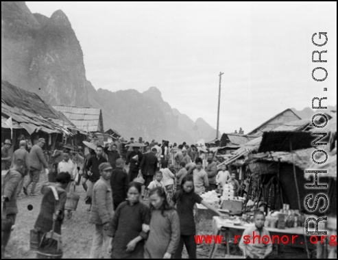 A bustling street at Liuzhou to the south of the river, near the American air base in WWII.  From the collection of Hal Geer.