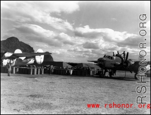 Refueling aircraft, B-25 on the right and B-24 on the left, at Liuzhou or Guilin, in Guangxi.  From the collection of Hal Geer.
