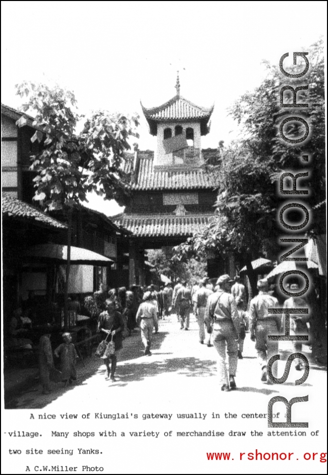 Drum or bell tower at the center of Kiunglai, with busy market street nearby, a shopping spot for GIs. During WWII.  Photo from C. W. Miller.