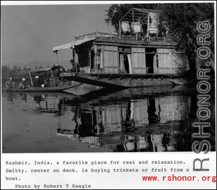 A boat on the water at Kashmir, India, during WWII, and Smitty, center on deck, buying trinkets or fruit from the bum boat.  Photo from Robert T. Keagle.