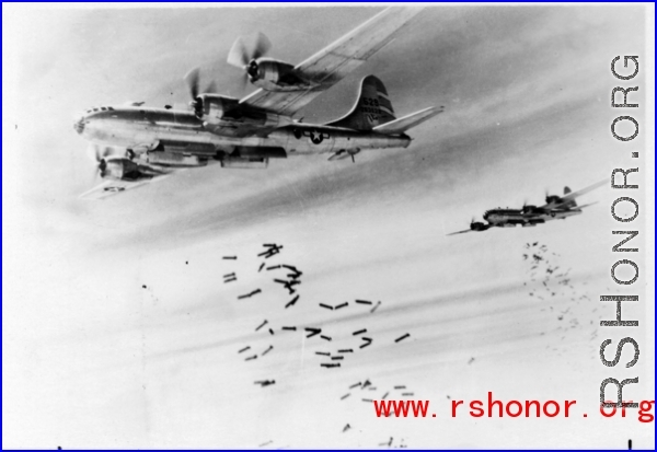 B-29 bombers in flight, dropping bombs. In the CBI during WWII.