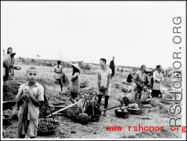 Roadside vendors sell vegetables in China during WWII.