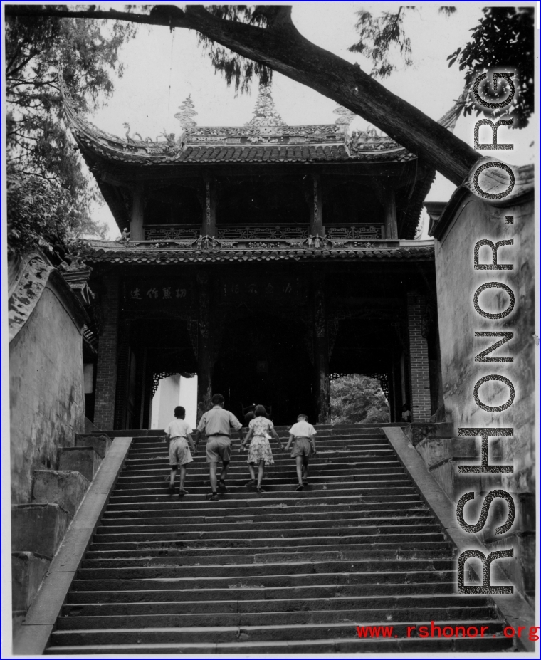A well-off Chinese family climbs steps to a temple in the CBI during WWII.
