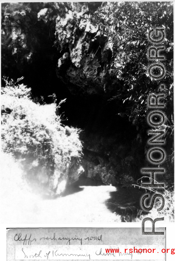 Karst cliffs overhanging road north of Kunming, May 1945.