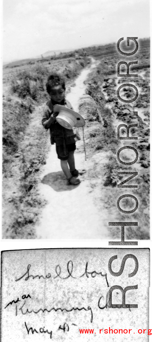 A small boy on a path amongst farm fields near Kunming, China, May 1945.