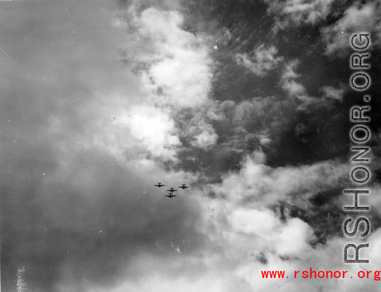 Four B-25 Mitchell bombers in flight in the CBI, in the area of southern China, Indochina, or Burma.