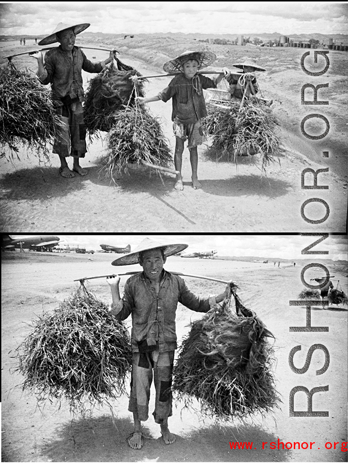 Farmers shoulder poles at Luliang air base during WWII.
