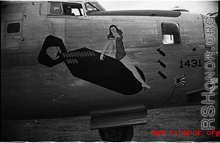Nose art of a B-24 bomber, showing a women riding a falling bomb. During WWII, in China.
