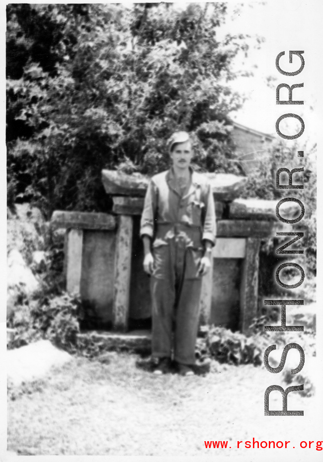GI Poses with Chinese grave marker in Yunnan, China, during WWII.