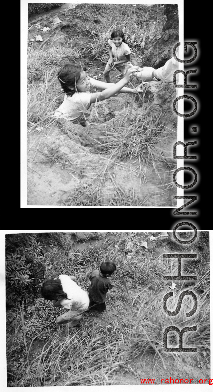 Children take a hand-out (presumably candy) from a GI. In Yunnan, China, during WWII.