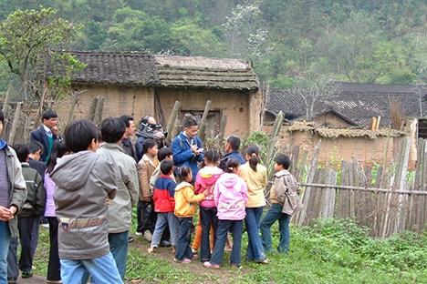 Commotion in the village upon our visit. The crumbling house in the background is where some of the Americans rested after being brought to the village so many years ago.