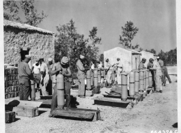 An exclusively African-American crew uncrate and prepare M47 A2 chemical incendiary bombs for use on on a 20th Bomber Command Boeing B-29 raid. China, during WWII.