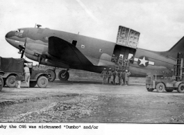 A C-46 Dumbo cargo airplane, #112413, on the ground, with cargo handlers, in the CBI.