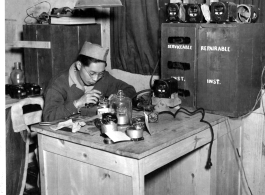 S/Sgt. Ed Toy of Chicago, Illinois, repairs instruments of Curtiss P-40s at an aircraft factory somewhere in China during WWII.  The factory was fitted to rebuild P-40s for the American Volunteer Group (AVG) and the Chinese continued the same operations for the U.S. Air Force.  January 1, 1943.