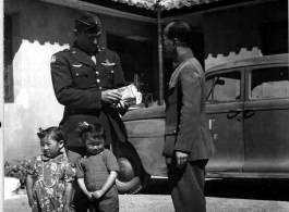 Chennault receives a bundle of Christmas greeting from China's children at the hand of his Chief Interpreter, Col. P. Y. Chu.