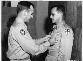 Lt. Colonel William D. Hopson Of Little Rock, Arkansas, Squadron Commander In A Heavy Bomber Group Of The "Flying Tigers", Receives The Distinguished Flying Cross From Major General Charles B. Stone At A 14Th Air Force Base In China. 19 September 1945.