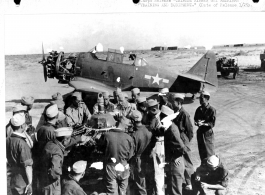 Chinese sergeants crowd around Sgt. Paul F. Brown as he conducts a class in ground repair. Instruction was via interpreter even though many of the Chinese sergeants speak English. In China during WWII.