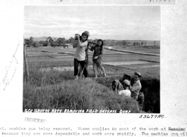 .50 cal machine gun being removed at Nanning Air Base during WWII by women laborers. 16 November 1944.  Image courtesy of Tony Strotman.