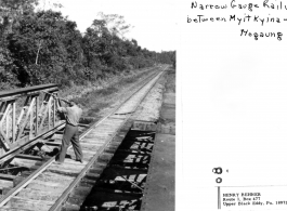 GI shoot rifle from bridge on narrow-gauge railway between Myitkyina and Mogaung, during WWII.  Photo from Henry Behner.