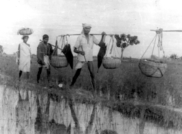 People cross field in at Misamari, India, during WWII.  Local images provided to Ex-CBI Roundup by "P. Noel" showing local people and scenes around Misamari, India.  In the CBI during WWII. 