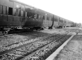 A long row of passenger train cars in India, during WWII.  In the CBI.